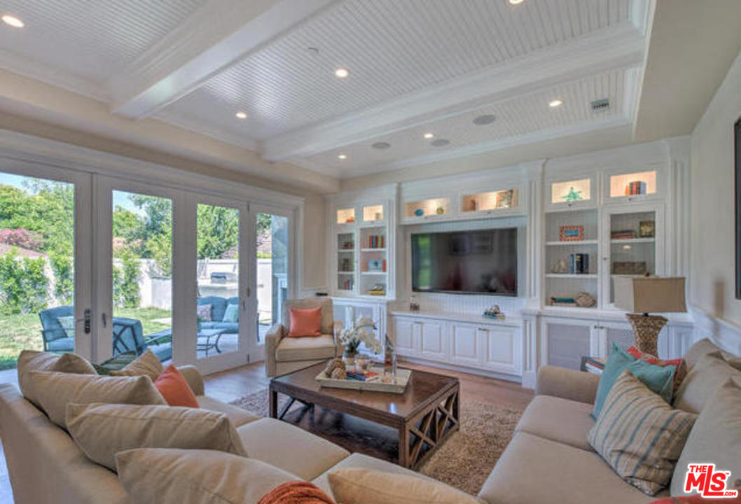 17841 Palora Street Encino, CA 91316 - Photo 11 of 33 a living room with furniture a flat screen tv and a large window