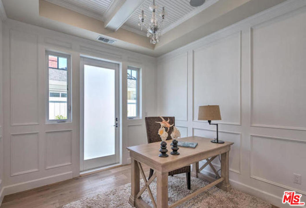 17841 Palora Street Encino, CA 91316 - Photo 12 of 33 a view of a workspace with furniture and a chandelier