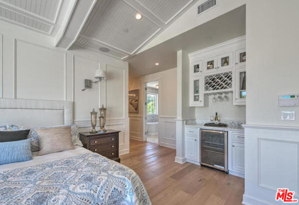 17841 Palora Street Encino, CA 91316 - Photo 17 of 33 a bedroom with a bed and a view of kitchen