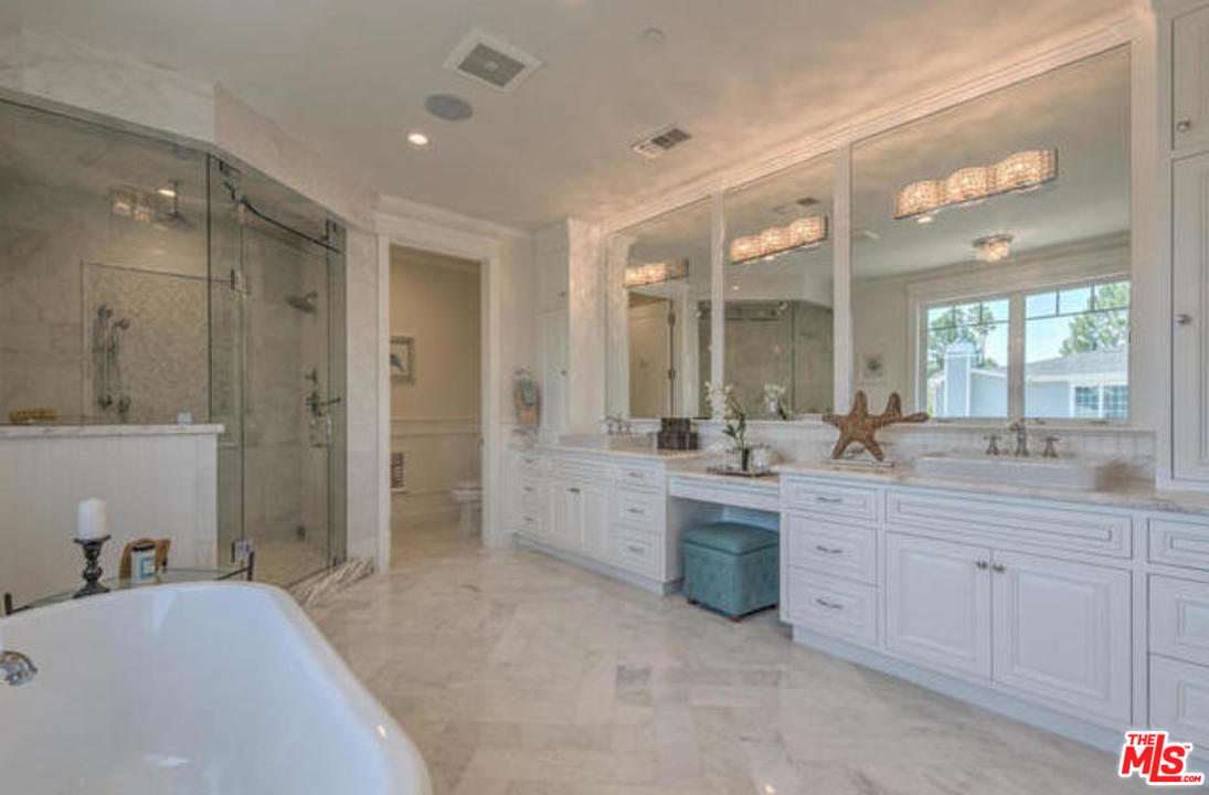 17841 Palora Street Encino, CA 91316 - Photo 19 of 33 a bathroom with a granite countertop sink mirror and a bathtub