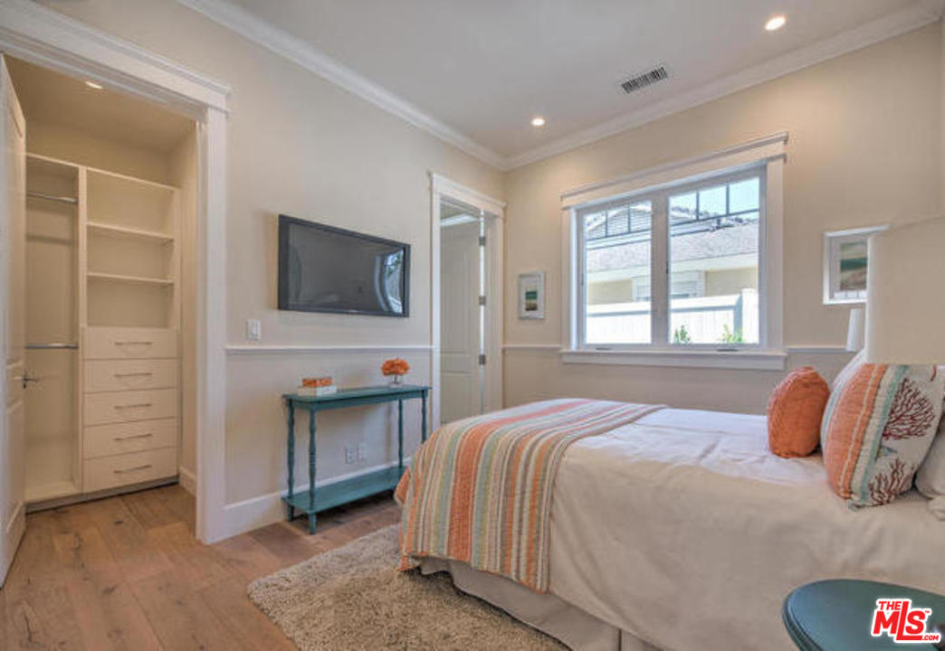 17841 Palora Street Encino, CA 91316 - Photo 22 of 33 a bedroom with a bed and a flat tv screen