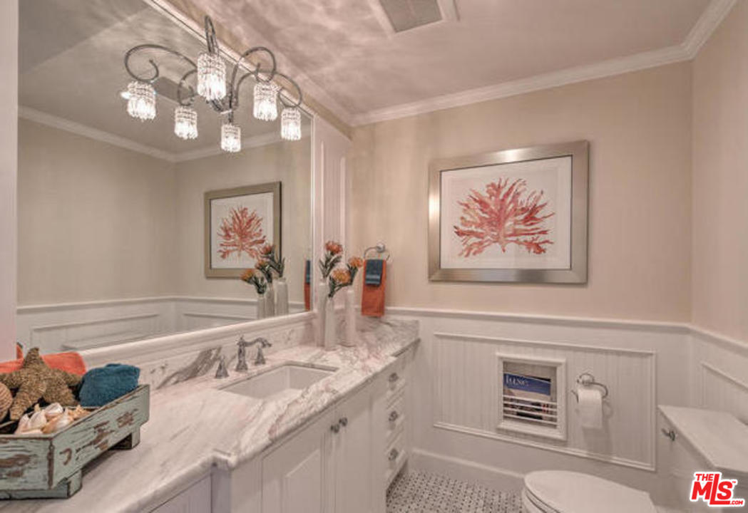 17841 Palora Street Encino, CA 91316 - Photo 23 of 33 a bathroom with a granite countertop sink a toilet and a mirror
