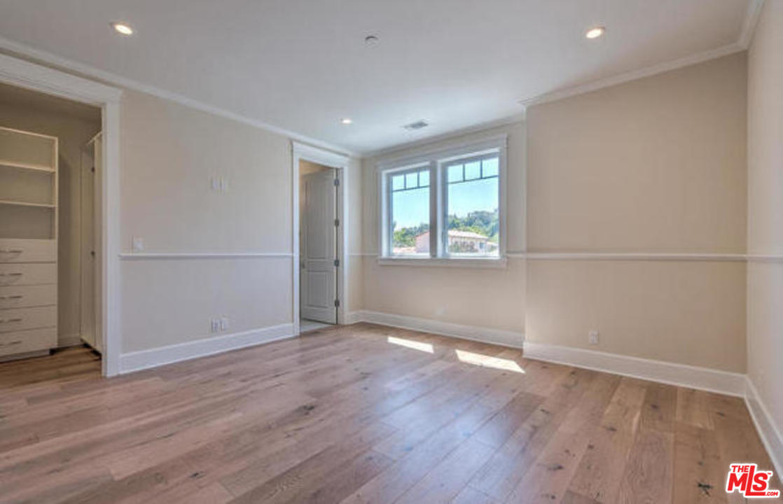 17841 Palora Street Encino, CA 91316 - Photo 24 of 33 an empty room with wooden floor and windows