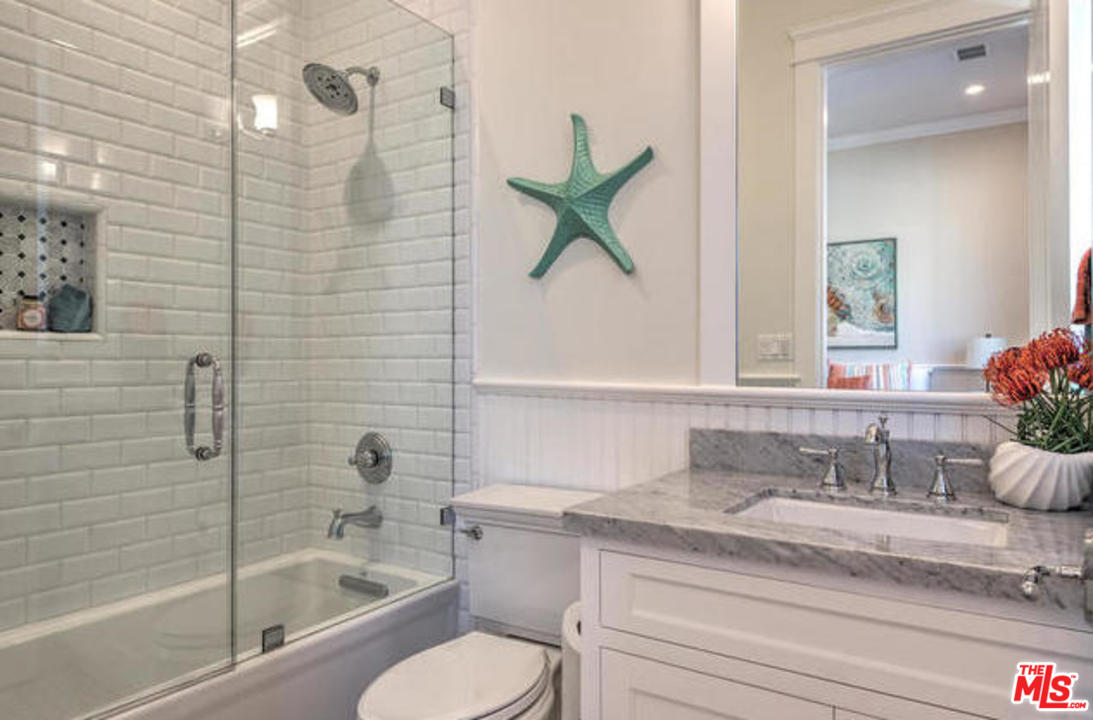 17841 Palora Street Encino, CA 91316 - Photo 25 of 33 a bathroom with a granite countertop sink a toilet and bathtub