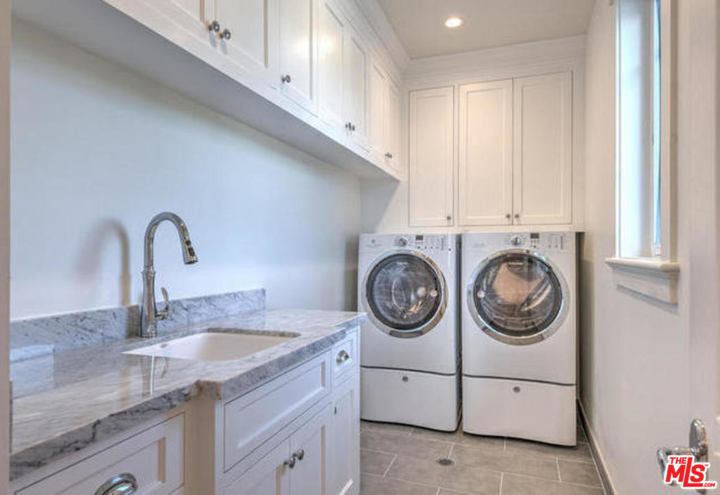 17841 Palora Street Encino, CA 91316 - Photo 26 of 33 a utility room with sink dryer and washer