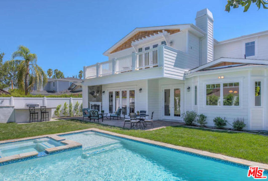 17841 Palora Street Encino, CA 91316 - Photo 31 of 33 a view of a house with a yard patio and swimming pool