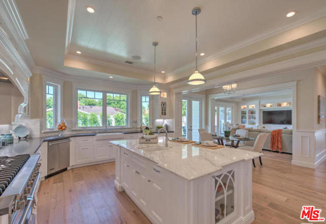 17841 Palora Street Encino, CA 91316 - Photo 7 of 33 a large kitchen with kitchen island a large island in it