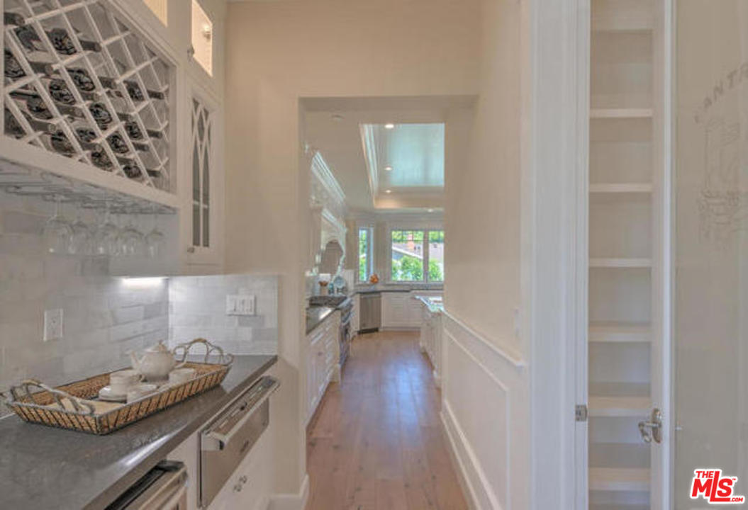 17841 Palora Street Encino, CA 91316 - Photo 10 of 33 a kitchen with granite countertop lots of counter top space and wooden floor