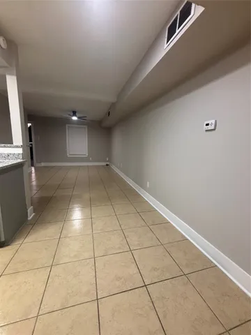 a view of a livingroom with an empty space and a window