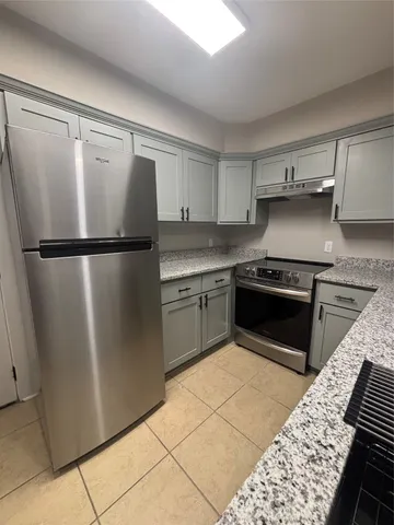 a kitchen with a refrigerator sink and stove