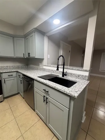 a kitchen with a sink cabinets and appliances