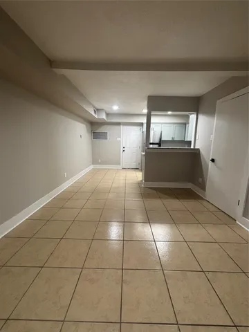 a spacious bathroom with a mirror and tiles