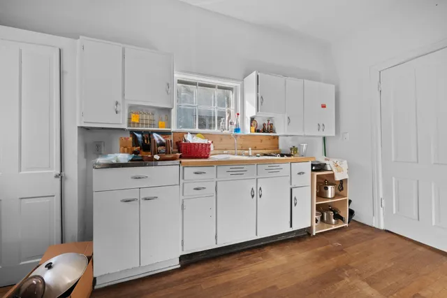 a kitchen with cabinets and window