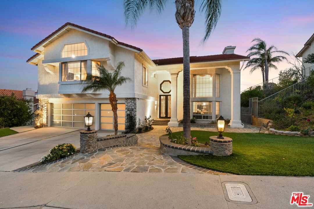 19800 Winged Foot Way Porter Ranch, CA 91326 - Photo 1 of 48 a front view of a house with garden