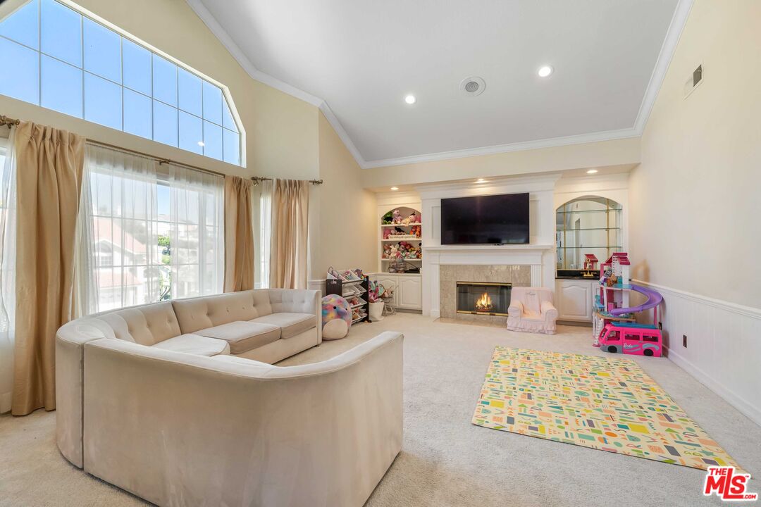19800 Winged Foot Way Porter Ranch, CA 91326 - Photo 24 of 48 a living room with fireplace furniture and a flat screen tv