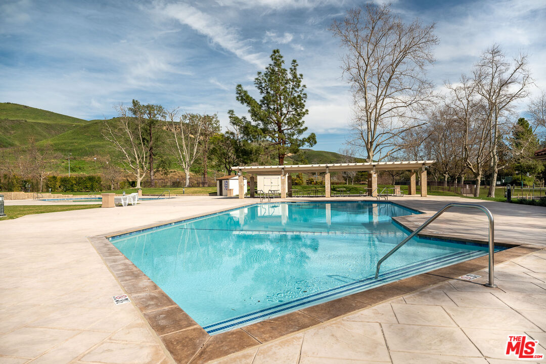 19800 Winged Foot Way Porter Ranch, CA 91326 - Photo 36 of 48 a view of a swimming pool with a lounge chairs