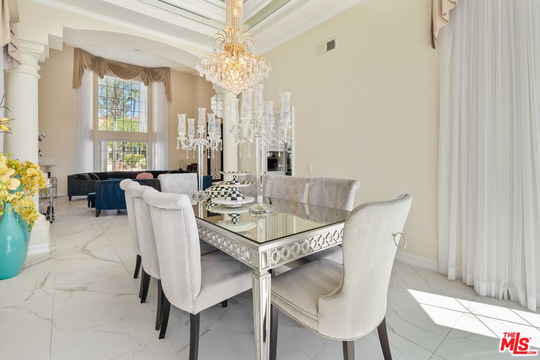 19800 Winged Foot Way Porter Ranch, CA 91326 - Photo 10 of 48 a dining room with furniture a chandelier and wooden floor