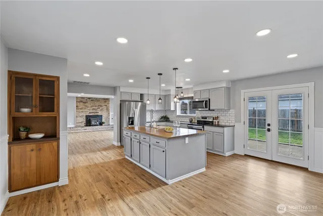 a kitchen with stainless steel appliances kitchen island wooden cabinets and granite counter tops