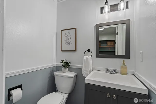 a bathroom with a toilet sink and mirror