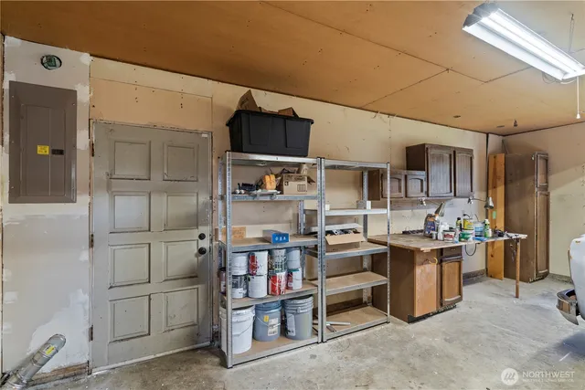 a view of kitchen with cabinets and window