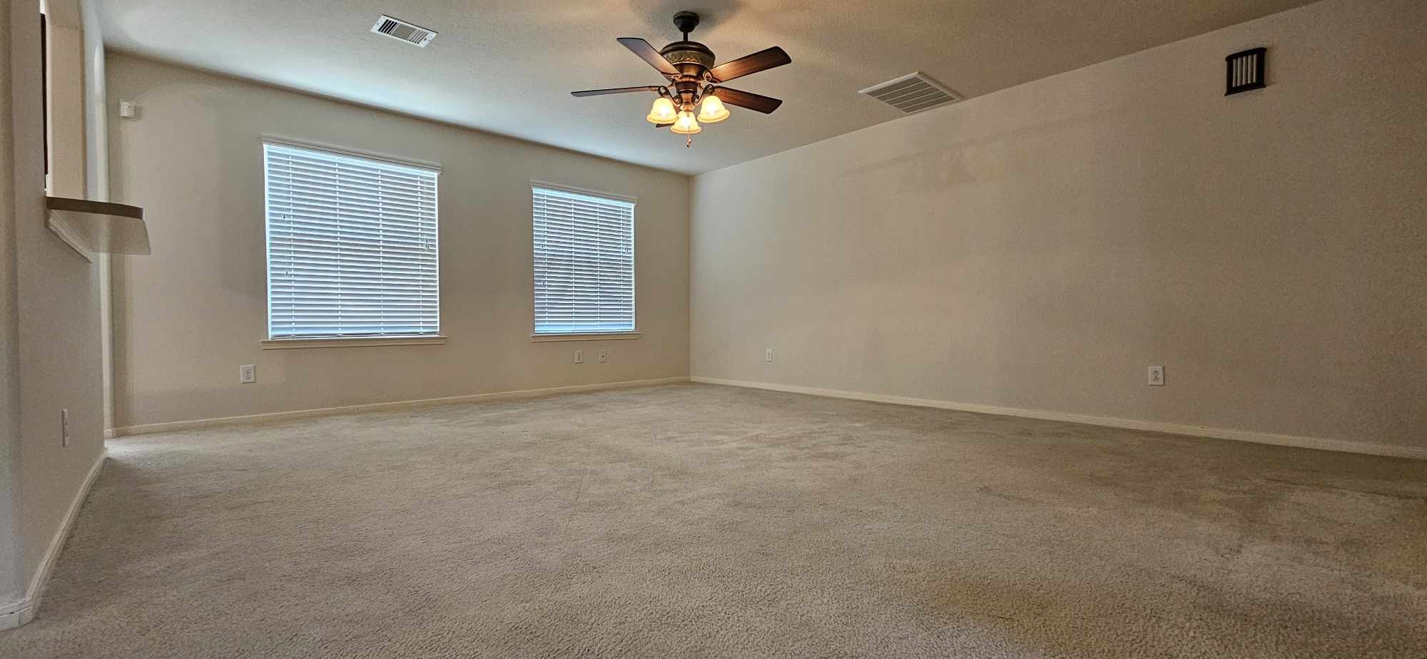 930 Sage Street Baytown, TX 77521 - Photo 11 of 27 a view of a room with a ceiling fan and a window