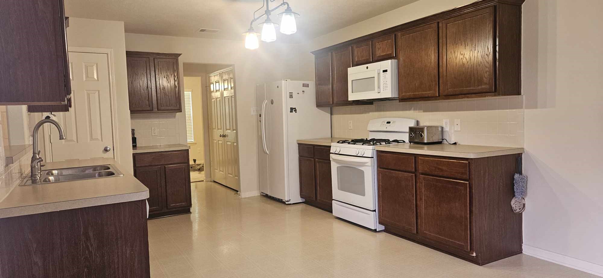 930 Sage Street Baytown, TX 77521 - Photo 17 of 27 a kitchen with a sink cabinets and stainless steel appliances