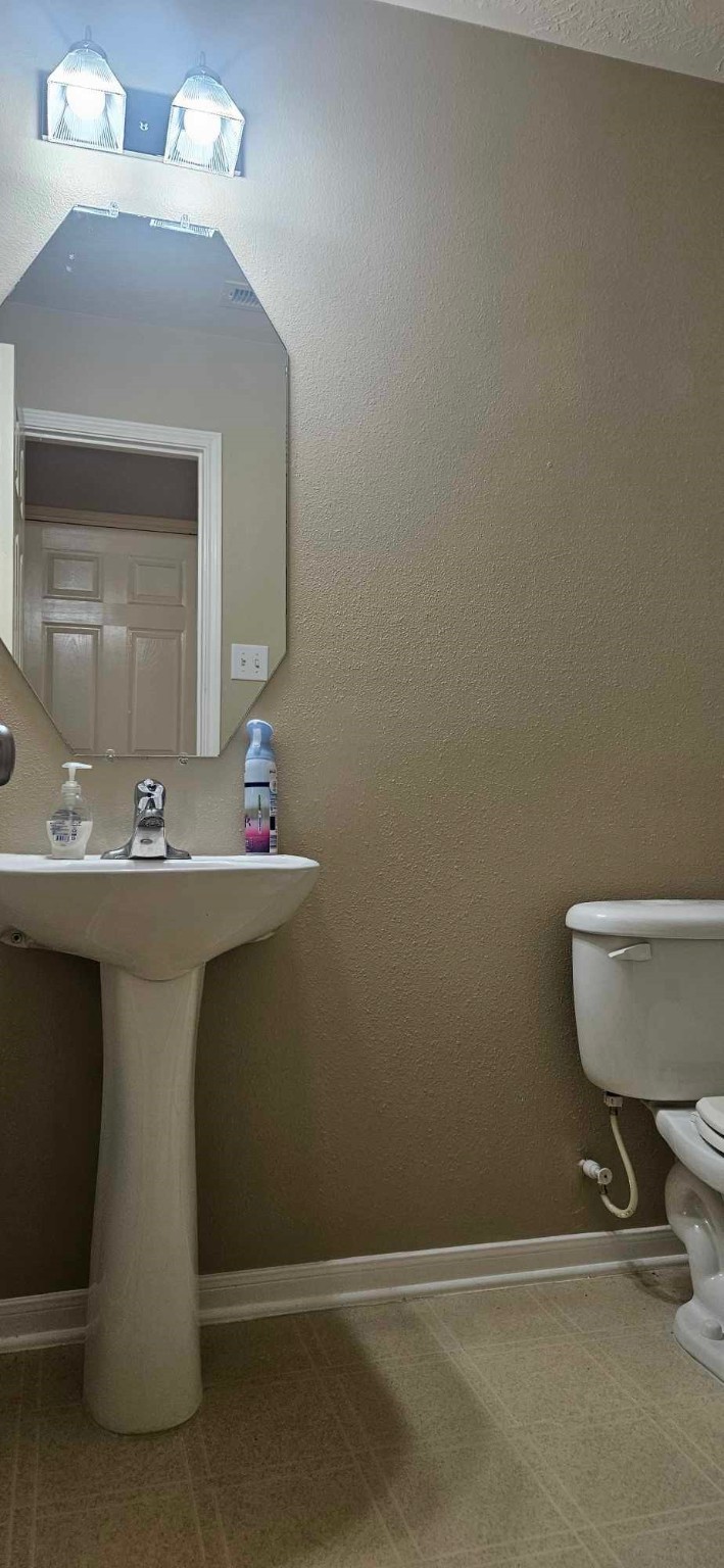 930 Sage Street Baytown, TX 77521 - Photo 19 of 27 a bathroom with a sink and a mirror