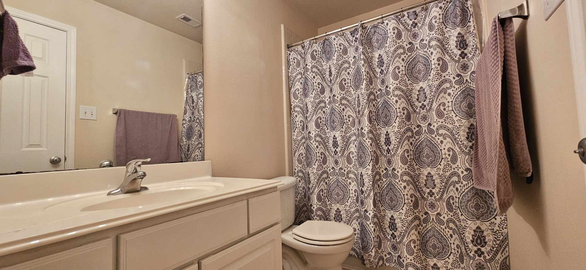930 Sage Street Baytown, TX 77521 - Photo 23 of 27 a bathroom with a sink toilet and shower