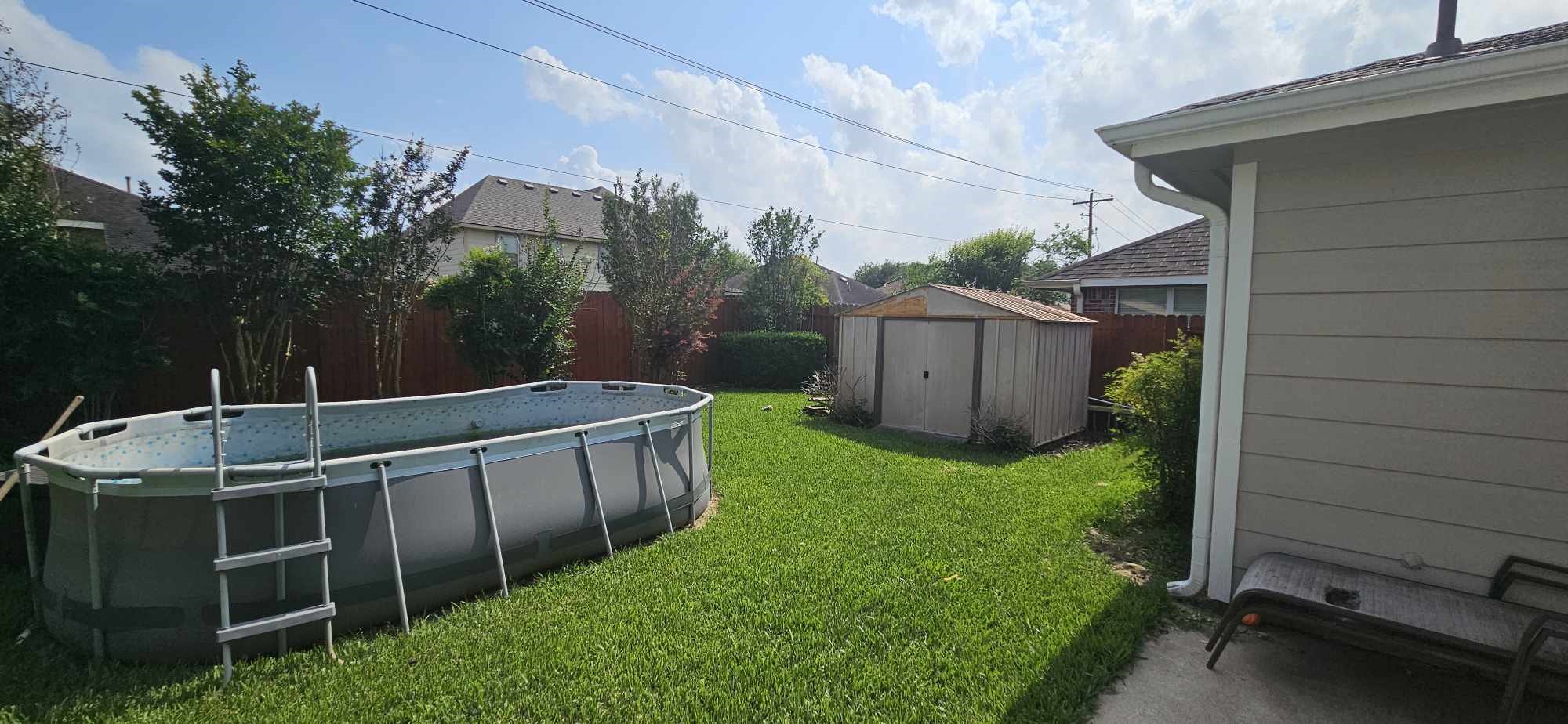 930 Sage Street Baytown, TX 77521 - Photo 27 of 27 a view of backyard with barbeque grill and wooden fence
