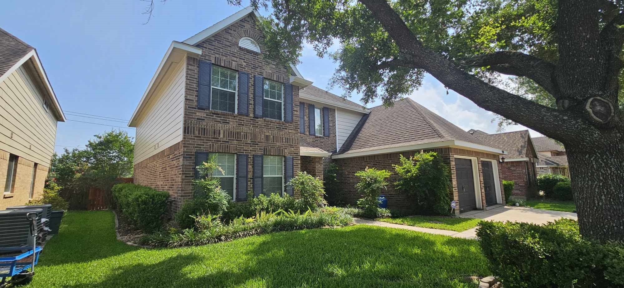 930 Sage Street Baytown, TX 77521 - Photo 3 of 27 a view of a yard in front of house