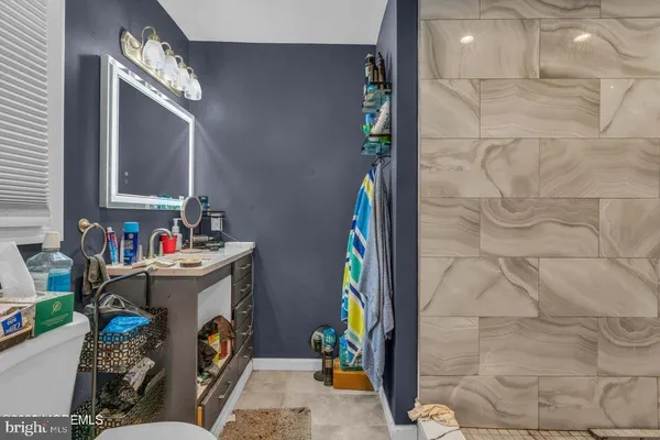 a bathroom with a sink mirror and window