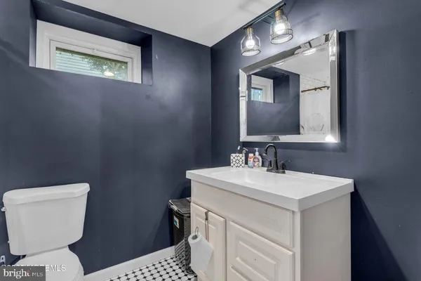 a bathroom with a sink a toilet a mirror and vanity