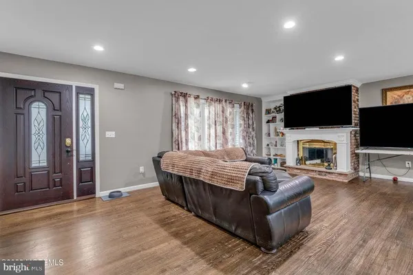 a living room with fireplace furniture and a flat screen tv
