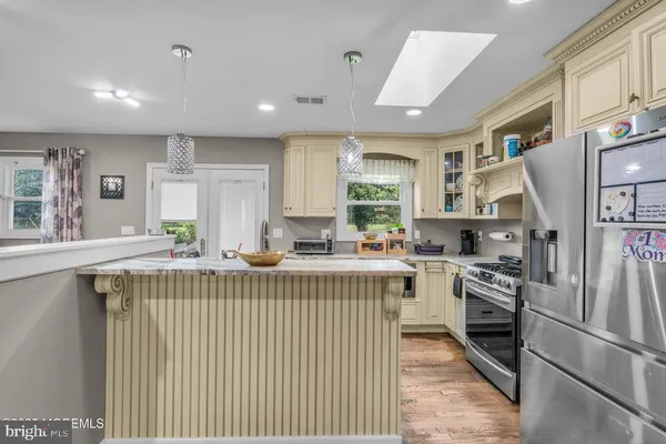a kitchen with counter top space appliances and windows