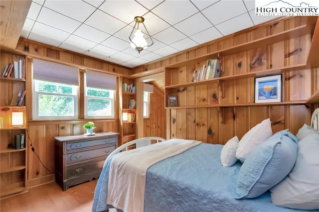 a bedroom with a bed closet and a large window