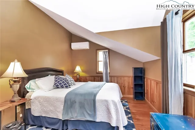 a bedroom with a bed and a lamp