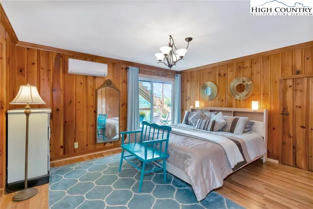 a bedroom with a bed and a chandelier