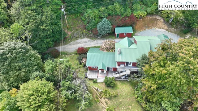 an aerial view of a house with swimming pool outdoor seating and yard