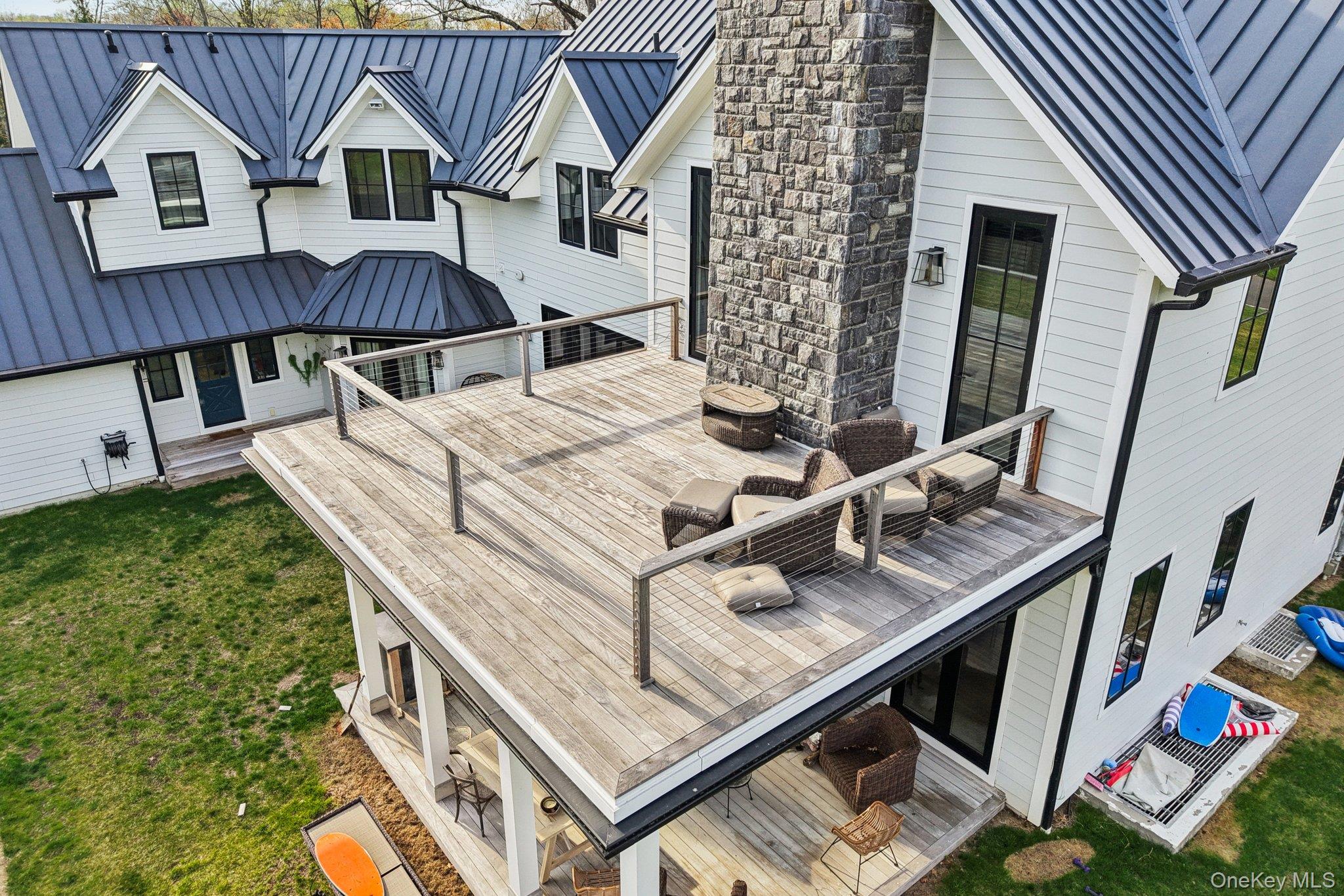 7 Marycrest Road West Nyack, NY 10994 - Photo 23 of 50 The property features a white exterior with black-framed windows and a dark metal roof