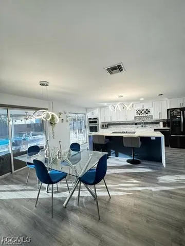 a living room with kitchen island furniture and a kitchen view