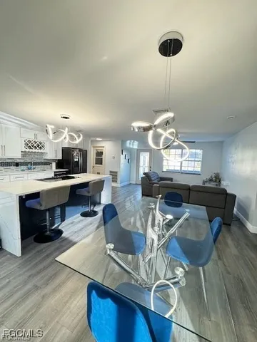 a living room with furniture a dining table and kitchen view