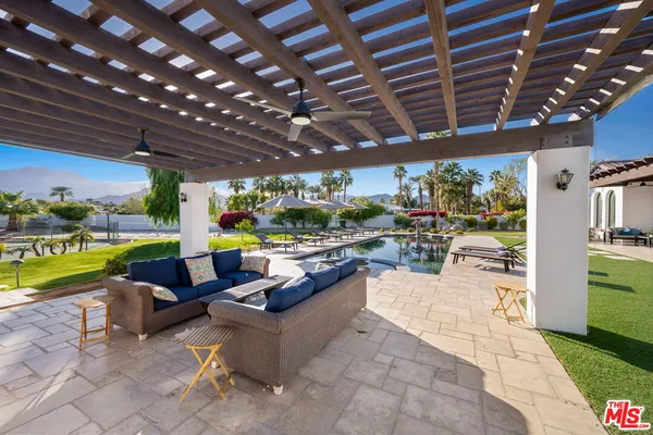 a view of a house with a yard and sitting area