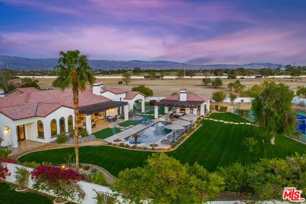 a view of a swimming pool and lounge chairs