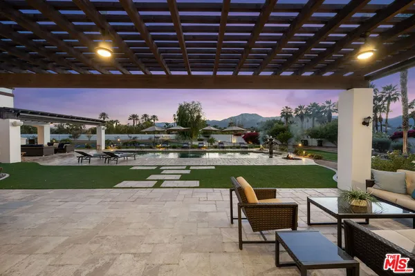 a view of a house with swimming pool and sitting area