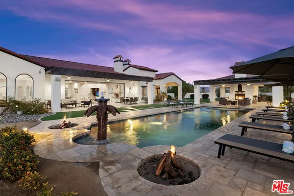 a living room with furniture a flat screen tv and a table