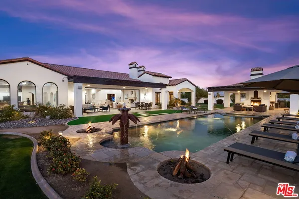 a view of a house with swimming pool and a yard
