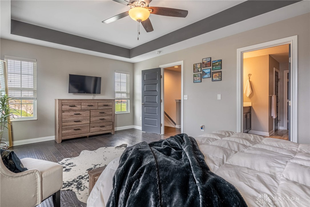 407 Brownstone Row Springboro, OH 45066 - Photo 26 of 54 This primary bedroom offers ample space with elegant flooring and a well-appointed ceiling.