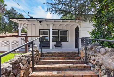 a view of a house with backyard and deck