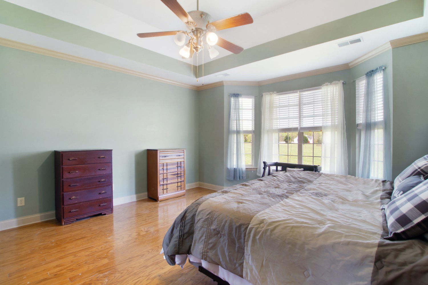 637 Ferrells Loop Road Manchester, TN 37355 - Photo 14 of 43 a bedroom with a large bed and a chandelier