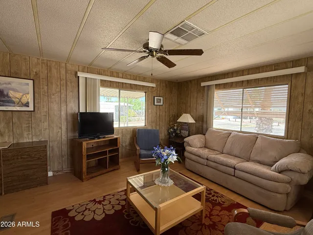 a living room with furniture a window and a flat screen tv